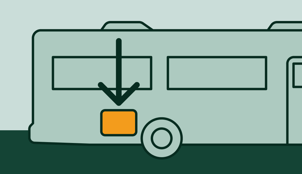 RV with a downward arrow pointing to an orange compartment, indicating the location of the water heater.